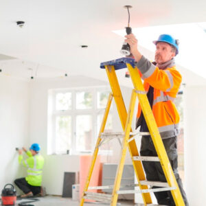 electrician installing downlights